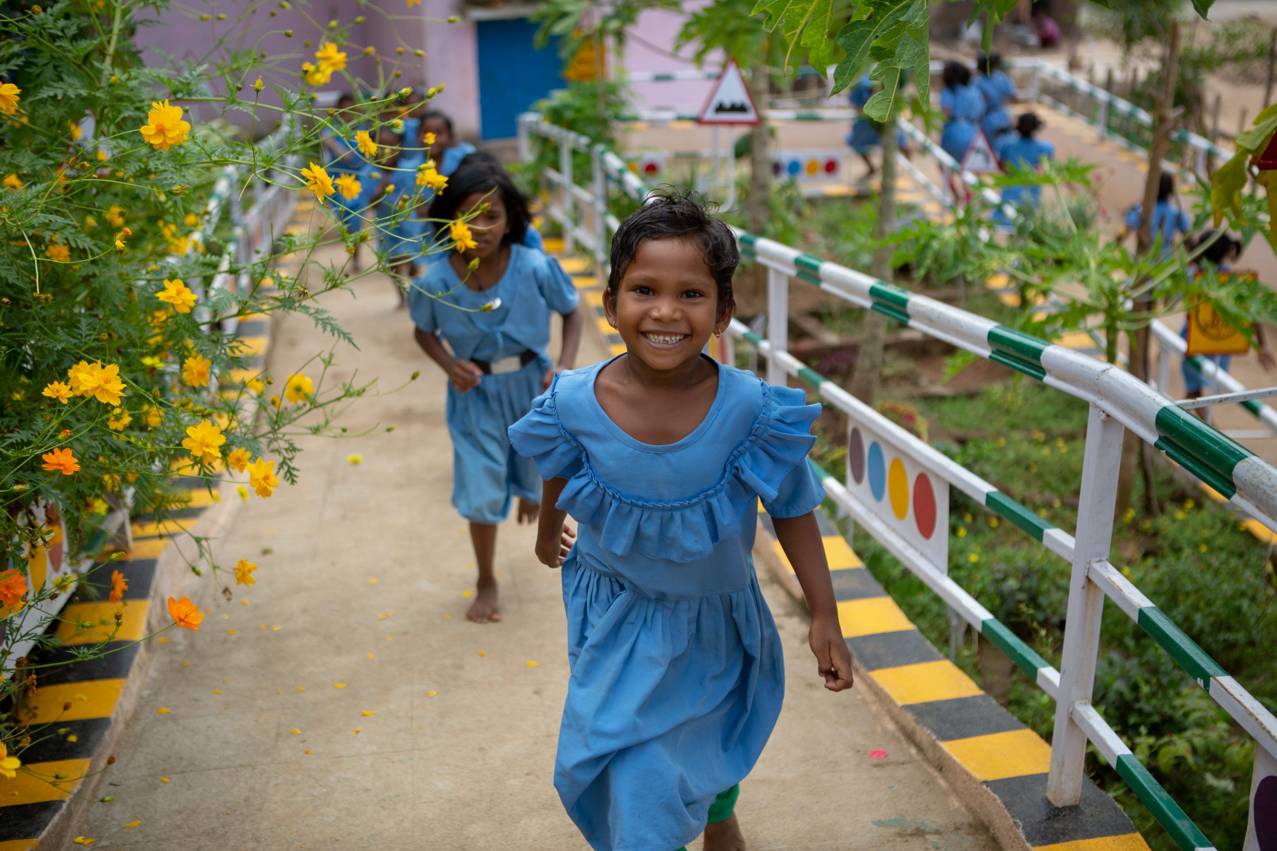 Deepika Jakaka, a 1st grader, plays with her classmates at the wonderfully green courtyard of the Ramachandrapur upper primary school in Rayagada district, Odisha. With so much of greenary surrouding the school, the children remain stress free and encouraged to learn. © UNICEF/UN0267942/Akhbar Latif